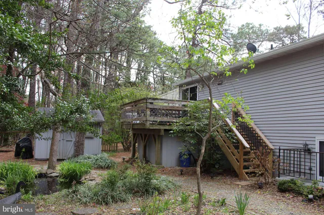 a front view of house with a garden