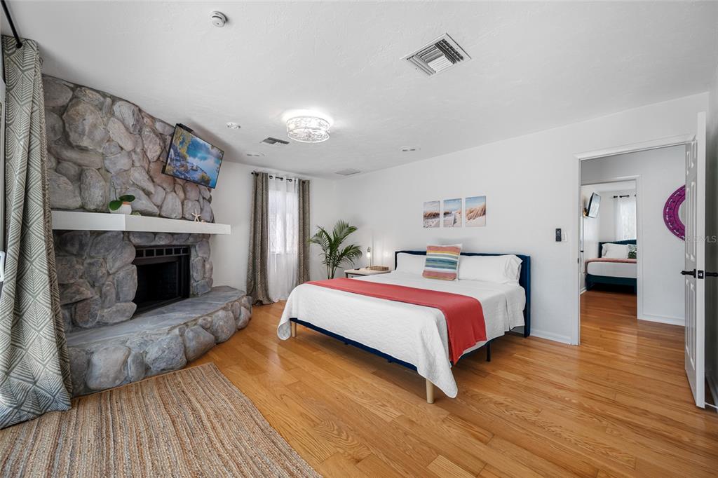 2153 Karan Way Clearwater, FL 33763 - Photo 39 of 65 a spacious bedroom with a bed and wooden floor