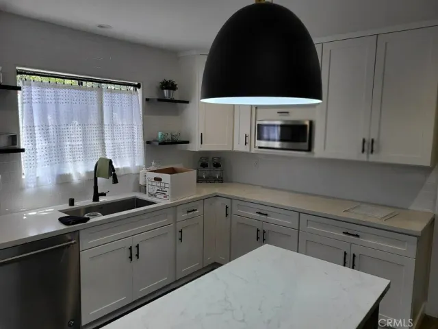 a kitchen with a sink a stove and microwave