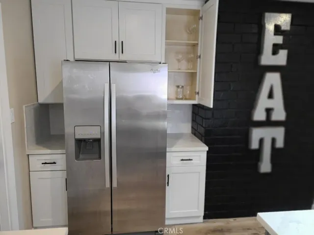 a kitchen with a refrigerator and cabinets