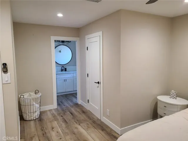 a large bed sitting in a bedroom next to a window