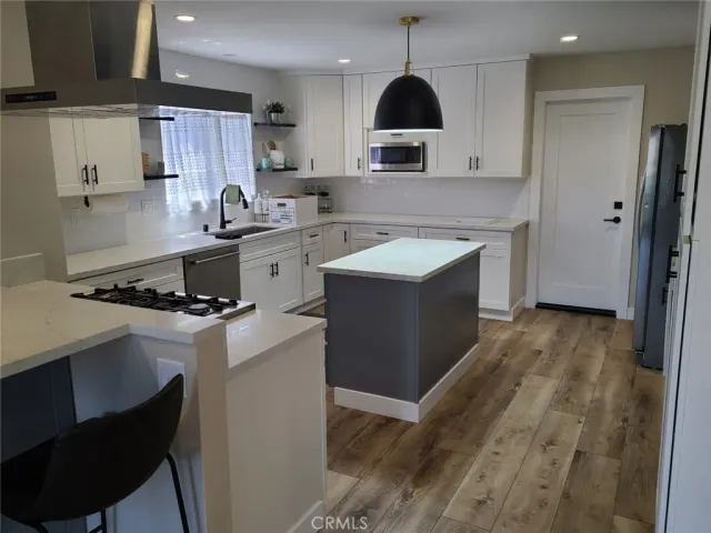 a kitchen with a sink stainless steel appliances and cabinets