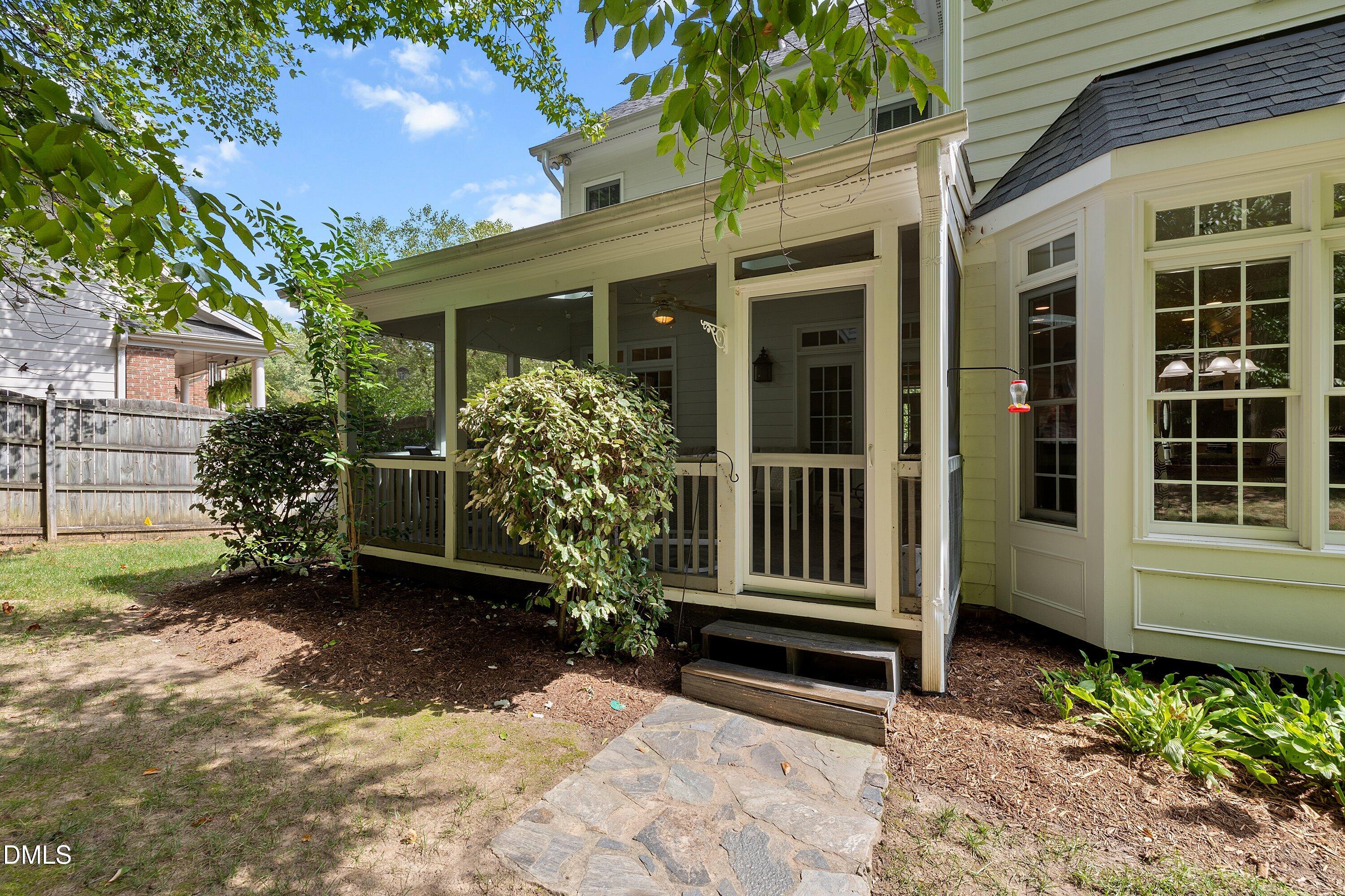 3914 Sterling Ridge Lane Durham, NC 27707 - Photo 54 of 66 Screened porch with white railings, stone pathway, and bay window with multiple panes