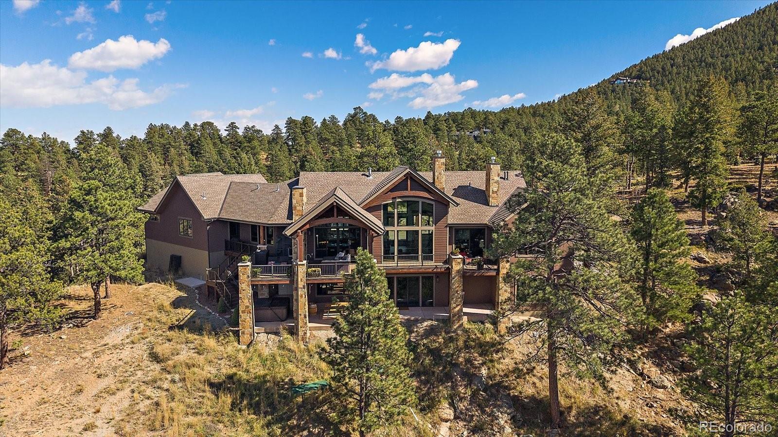 4331 Hilltop Road Evergreen, CO 80439 - Photo 1 of 45 a view of a house with a yard and hanging chair