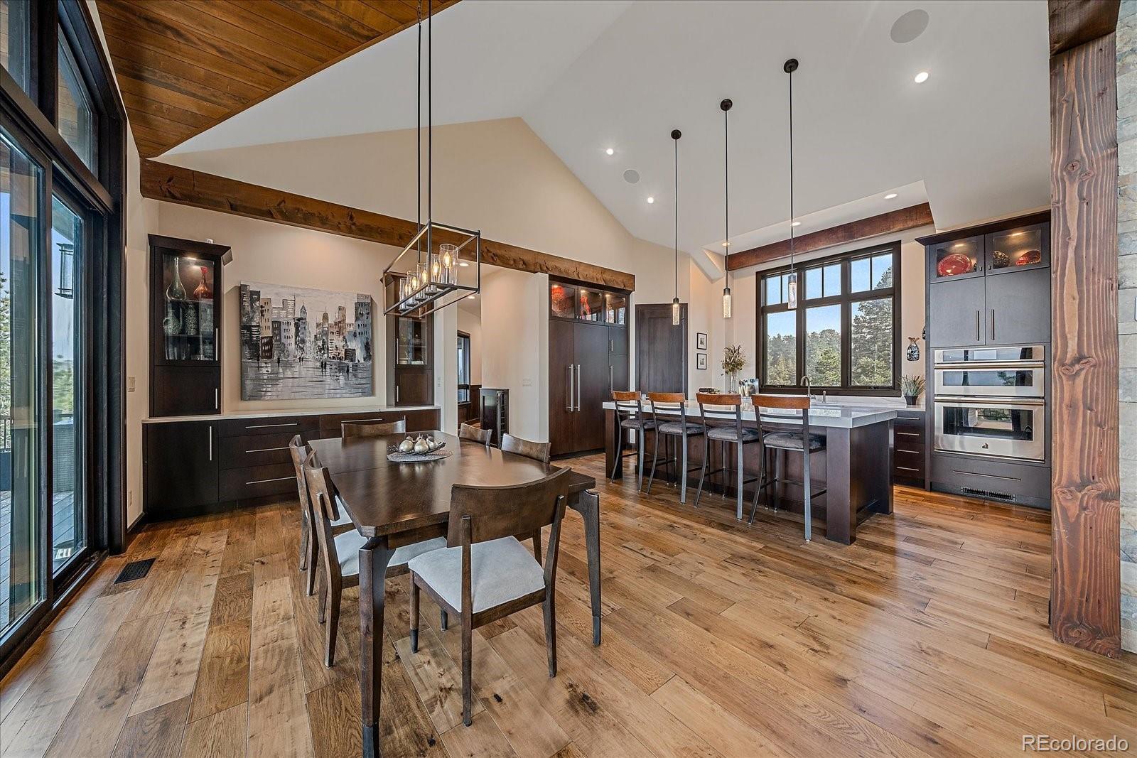 4331 Hilltop Road Evergreen, CO 80439 - Photo 11 of 45 a view of a dining room with furniture window and wooden floor