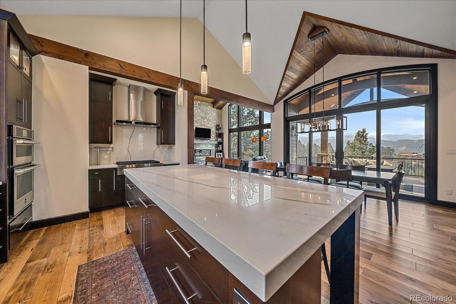 4331 Hilltop Road Evergreen, CO 80439 - Photo 14 of 45 a kitchen with stainless steel appliances granite countertop a sink a stove and a refrigerator