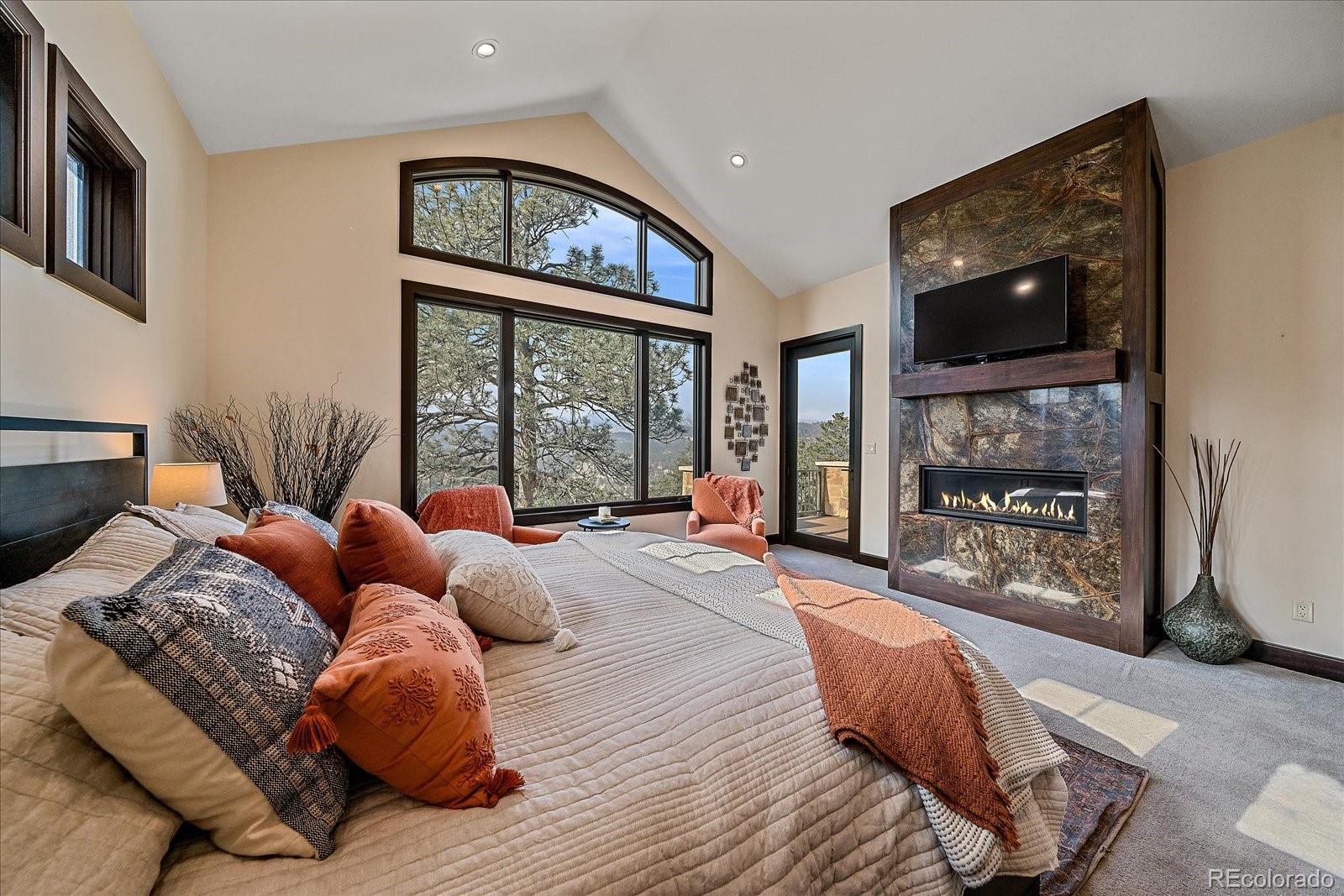 4331 Hilltop Road Evergreen, CO 80439 - Photo 16 of 45 a bedroom with furniture and a window