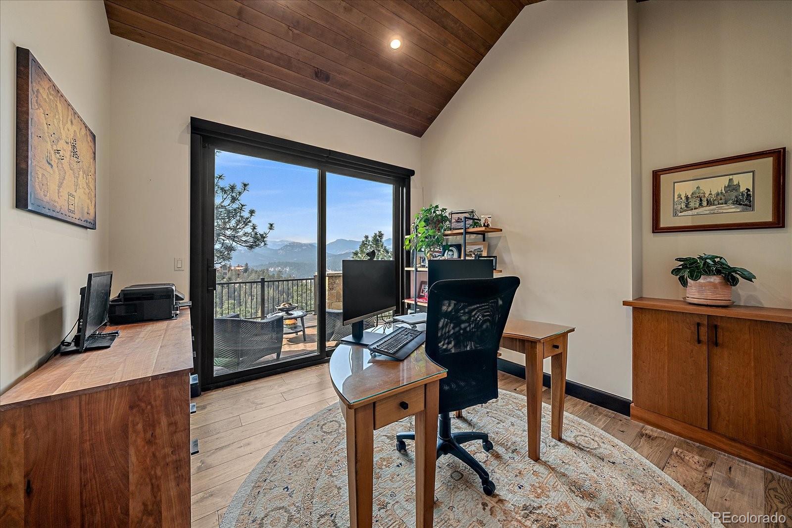 4331 Hilltop Road Evergreen, CO 80439 - Photo 20 of 45 a workspace with furniture and a gate