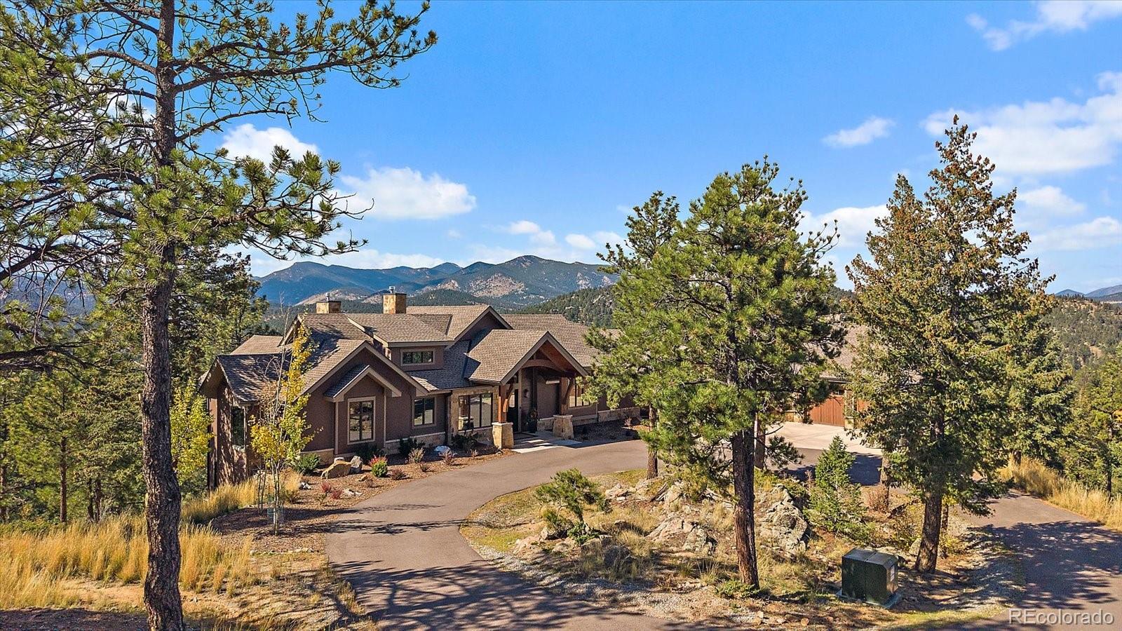 4331 Hilltop Road Evergreen, CO 80439 - Photo 2 of 45 a front view of a house with a yard