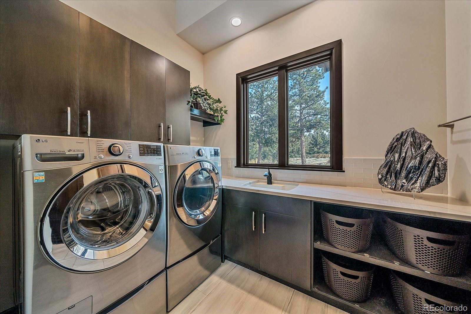4331 Hilltop Road Evergreen, CO 80439 - Photo 21 of 45 a utility room with sink dryer and washer
