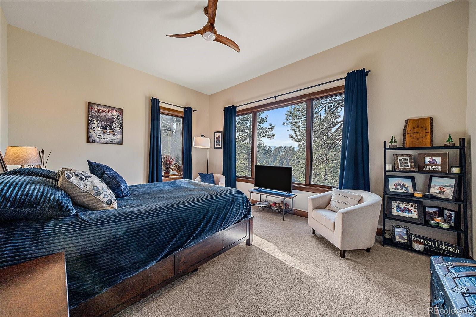 4331 Hilltop Road Evergreen, CO 80439 - Photo 28 of 45 a bedroom with a large bed couch and a window