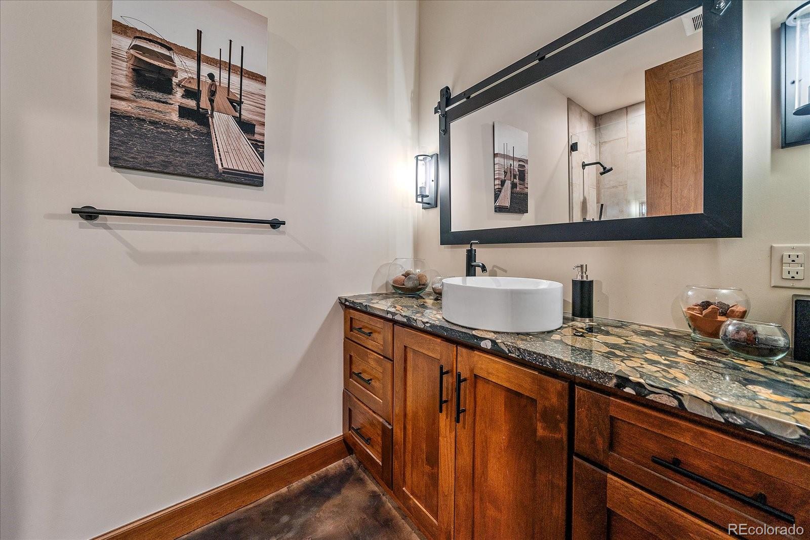 4331 Hilltop Road Evergreen, CO 80439 - Photo 30 of 45 a bathroom with a sink and a mirror
