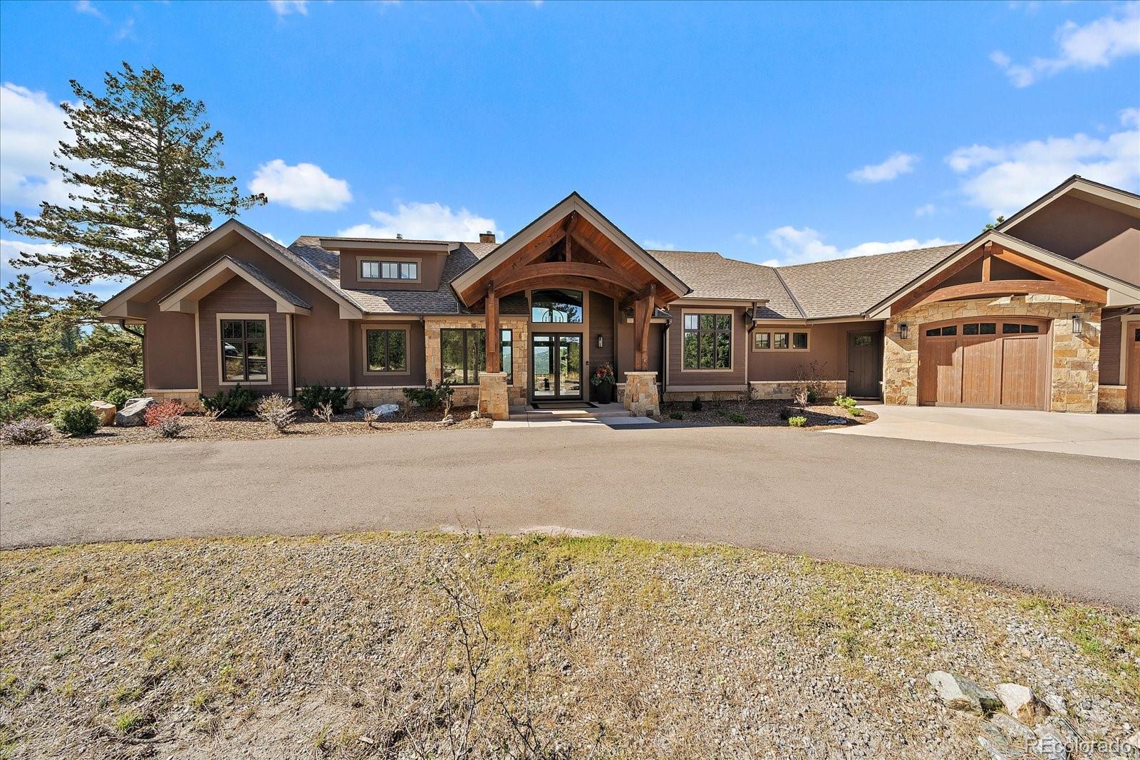 4331 Hilltop Road Evergreen, CO 80439 - Photo 3 of 45 a front view of a house with a yard