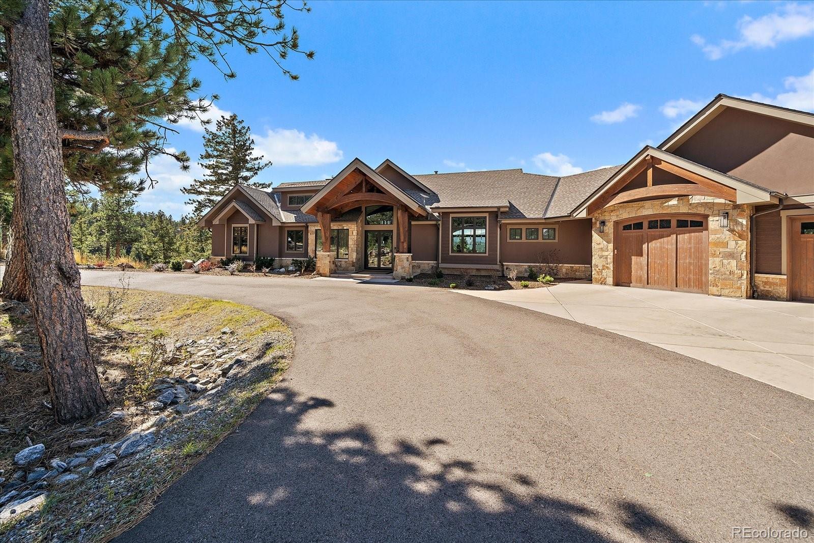 4331 Hilltop Road Evergreen, CO 80439 - Photo 35 of 45 a front view of a house with a yard