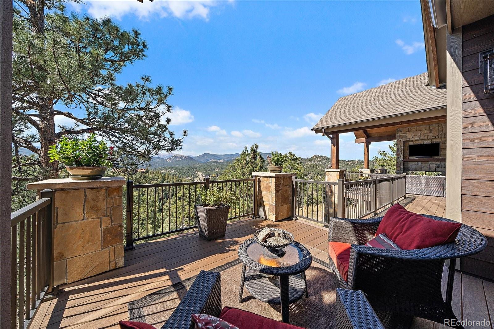 4331 Hilltop Road Evergreen, CO 80439 - Photo 39 of 45 a view of a balcony with chairs and a potted plant