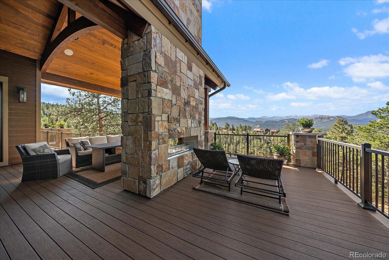 4331 Hilltop Road Evergreen, CO 80439 - Photo 40 of 45 a roof deck with couches and wooden floor