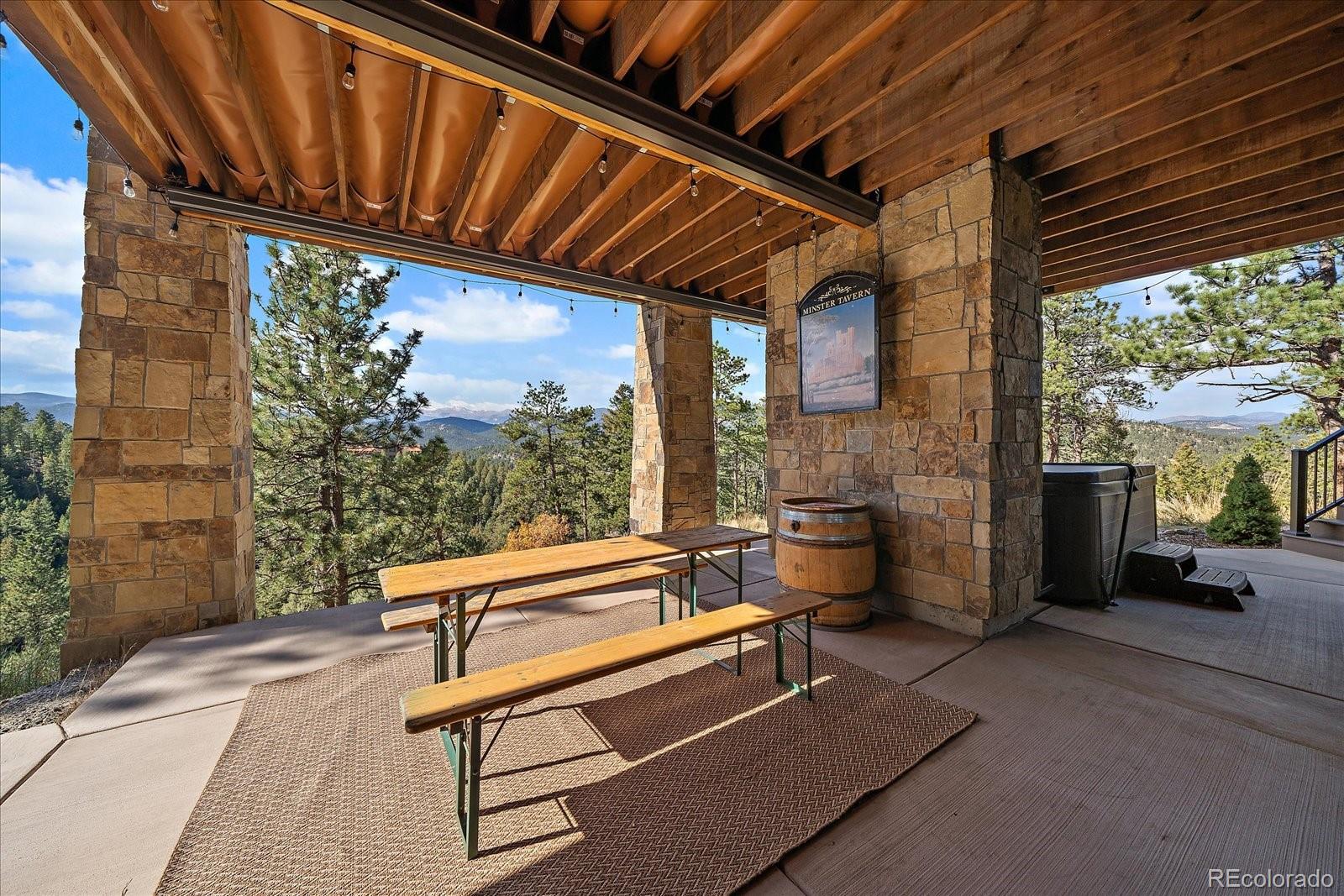 4331 Hilltop Road Evergreen, CO 80439 - Photo 41 of 45 a backyard of a house with outdoor seating