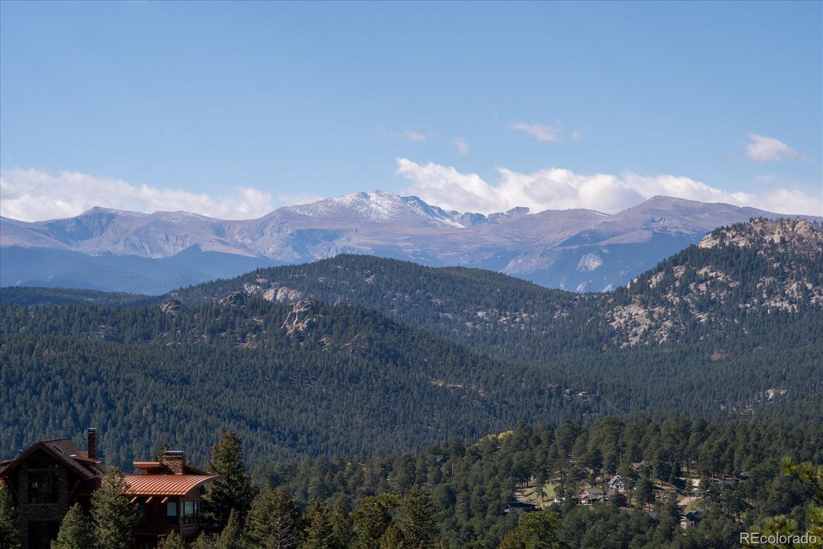 4331 Hilltop Road Evergreen, CO 80439 - Photo 43 of 45 a view of a town with mountains in the background