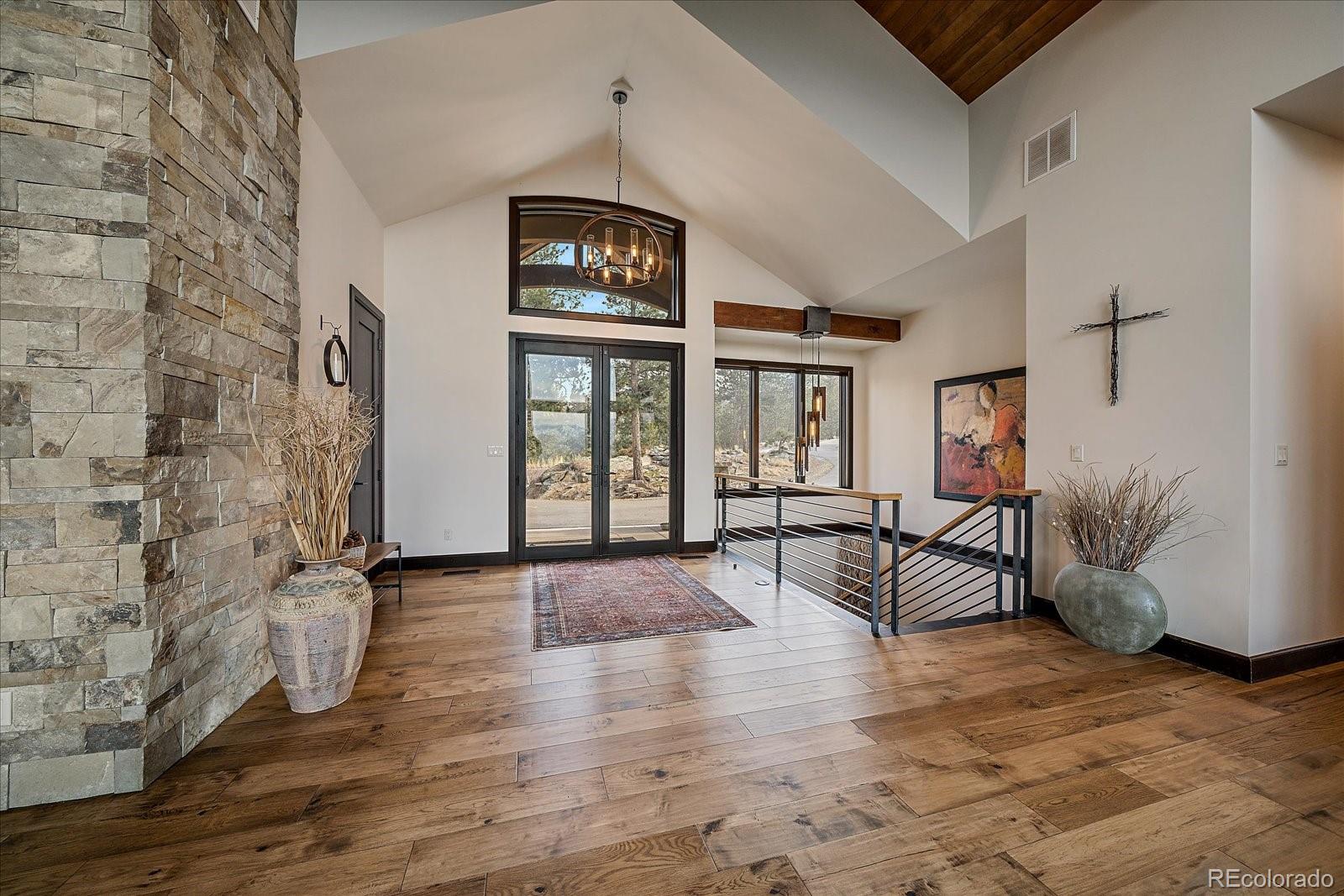 4331 Hilltop Road Evergreen, CO 80439 - Photo 6 of 45 wooden floor in an empty room with a window