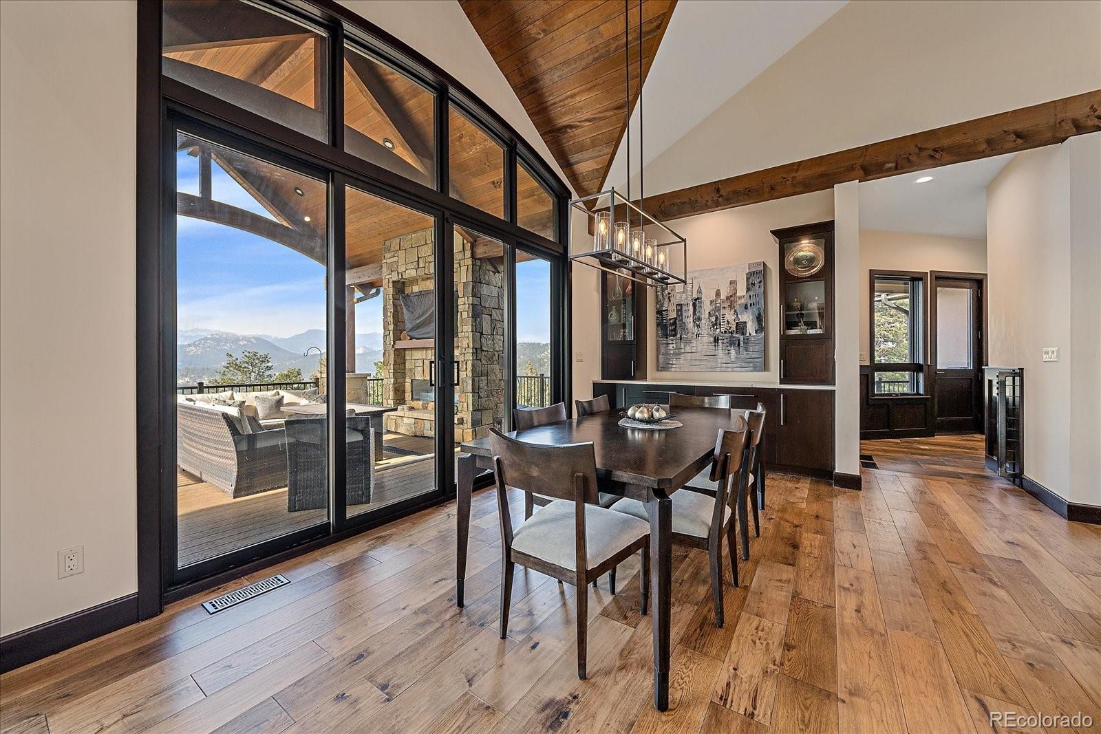 4331 Hilltop Road Evergreen, CO 80439 - Photo 9 of 45 a dining room with furniture window and wooden floor