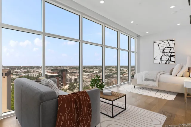 a bedroom with furniture and large windows