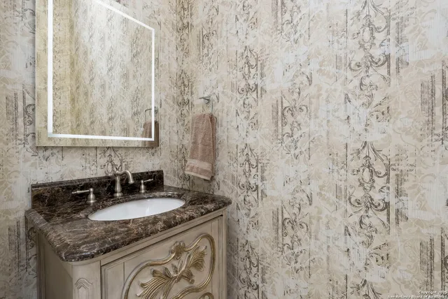 a kitchen with stainless steel appliances granite countertop a sink a stove and a refrigerator