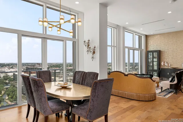 a kitchen with granite countertop a refrigerator a stove and a sink with wooden floor