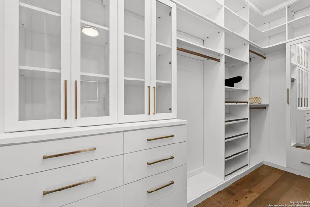 a living room with lots of furniture and a view of kitchen