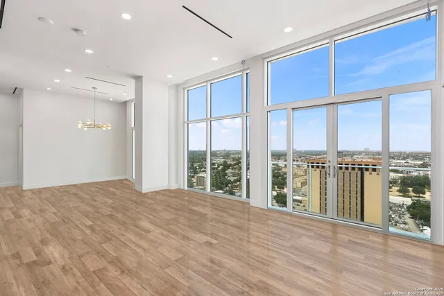 a open kitchen with stainless steel appliances granite countertop a refrigerator and a wooden floors