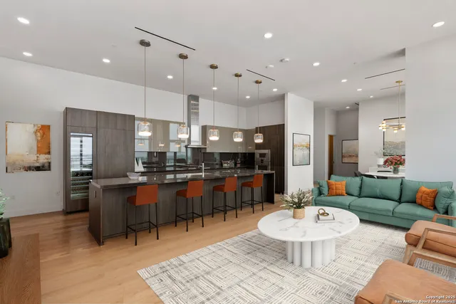 a living room with furniture tv and large windows