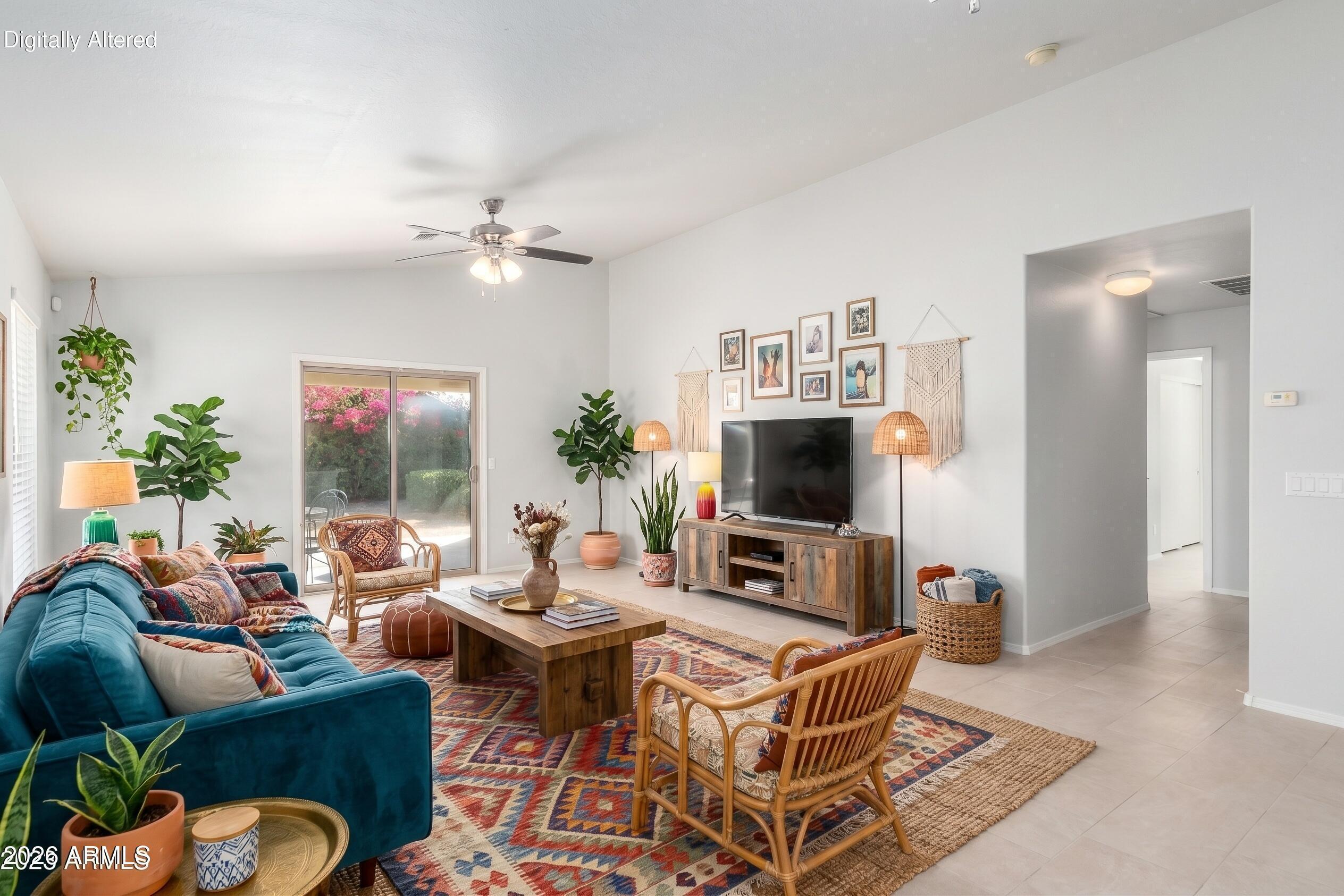 17715 West Redfield Road Surprise, AZ 85388 - Photo 9 of 36 a living room with furniture a flat screen tv and a table