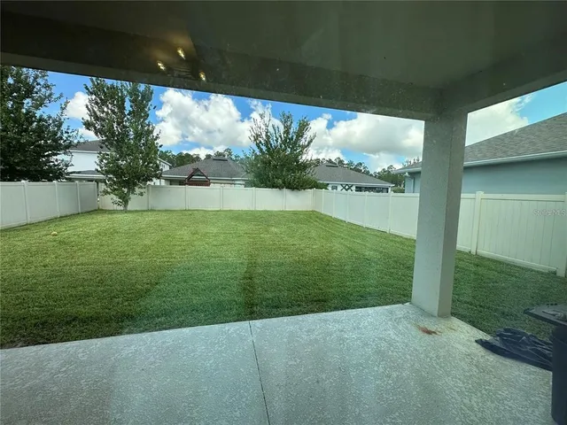 a view of kitchen dining table chairs microwave and cabinets