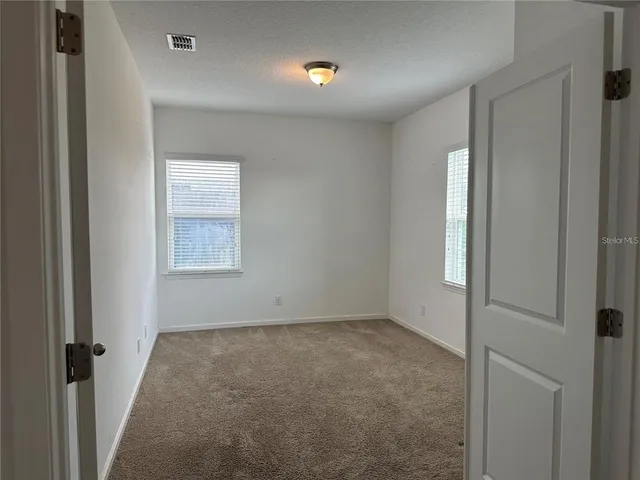 a utility room with cabinets washer and dryer