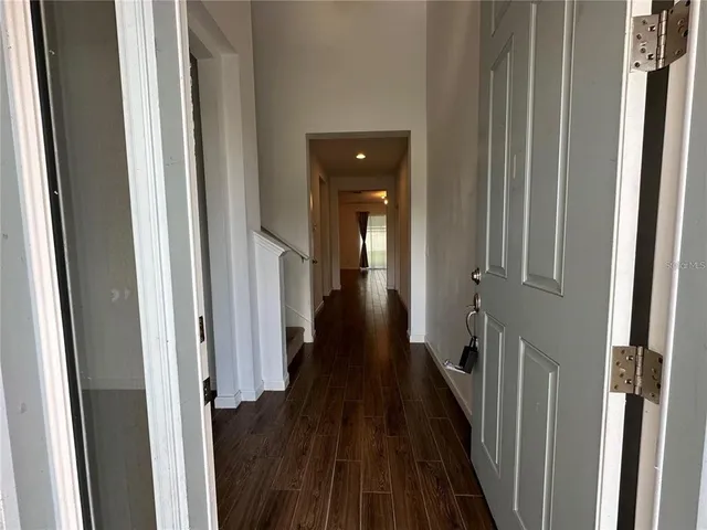 a view of a hallway with wooden floor