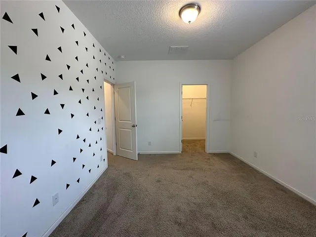 a bathroom with a granite countertop sink a light fixture and a mirror