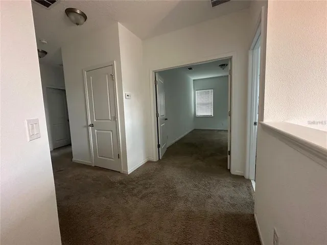 a large kitchen with stainless steel appliances granite countertop a stove a sink and a refrigerator