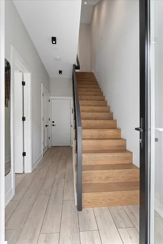 a view of entryway and hall with wooden floor