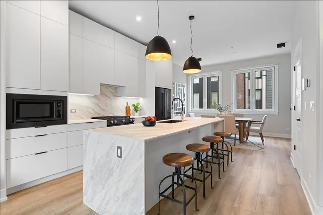 a kitchen with cabinets and wooden floor