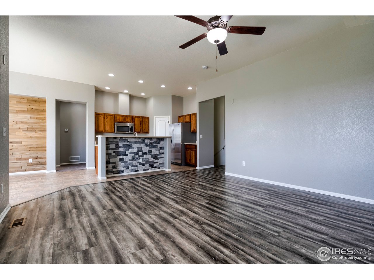 7424 23rd St Road Greeley, CO 80634 - Photo 23 of 40 Living room looking into kitchen