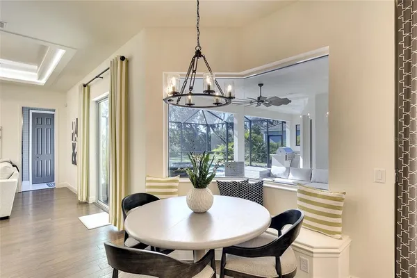 a view of a dining room with furniture wooden floor and chandelier