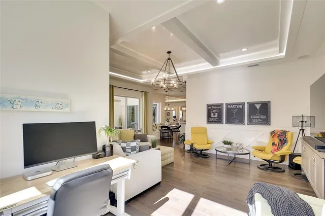 a living room with furniture or chandelier and a flat screen tv