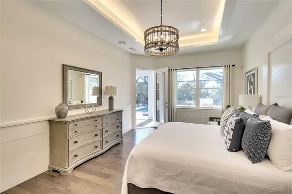 a bedroom with a large bed and a dresser