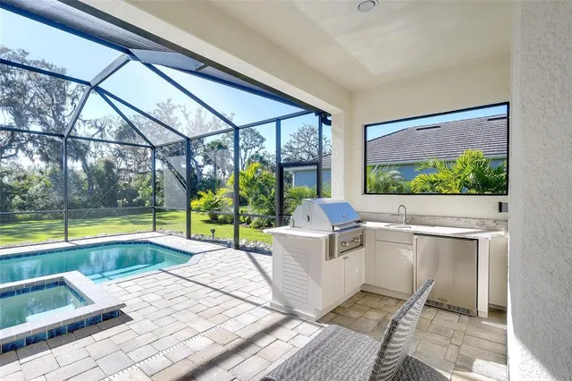 a living room with a large window and a table and chairs
