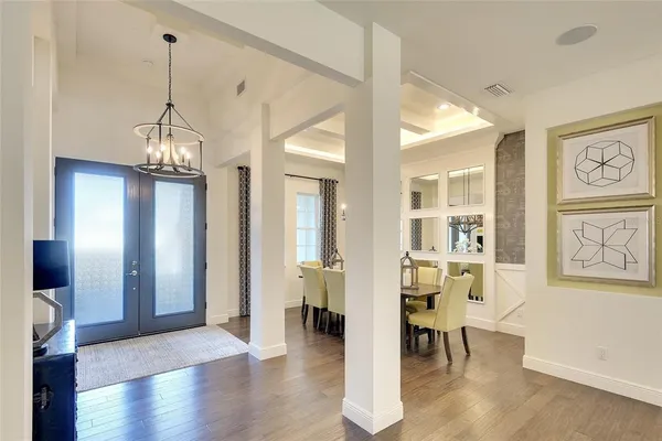 a view of a room with furniture and wooden floor