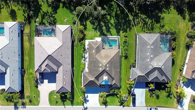 an aerial view of multiple houses with yard