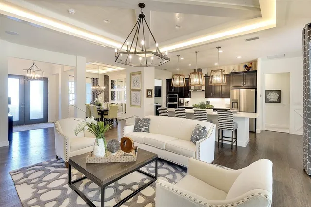 a living room with lots of furniture and kitchen view