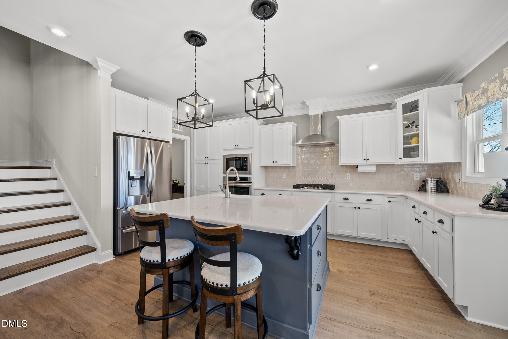 320 Kavanaugh Road Wake Forest, NC 27587 - Photo 11 of 32 a kitchen with stainless steel appliances kitchen island granite countertop a table chairs in it and white cabinets