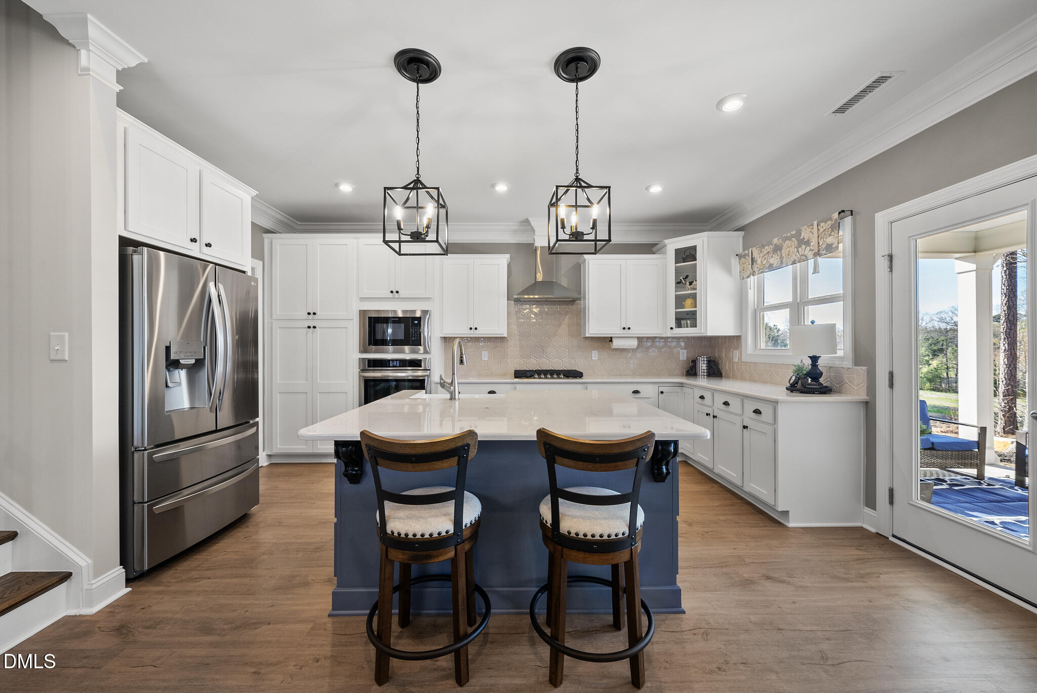 320 Kavanaugh Road Wake Forest, NC 27587 - Photo 13 of 32 a kitchen with stainless steel appliances kitchen island granite countertop a refrigerator a stove a sink dishwasher a dining table and chairs with wooden floor