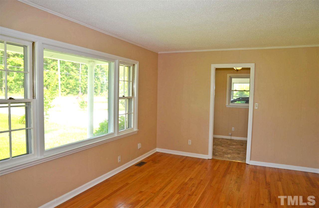 4228 Lassiter Road Wake Forest, NC 27587 - Photo 12 of 20 a view of an empty room with wooden floor and a window