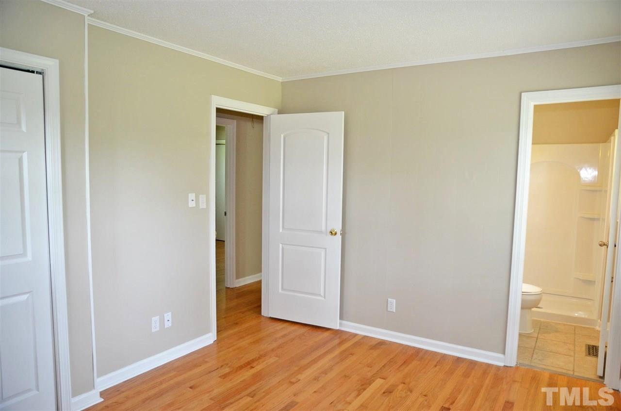 4228 Lassiter Road Wake Forest, NC 27587 - Photo 13 of 20 a view of an empty room with wooden floor
